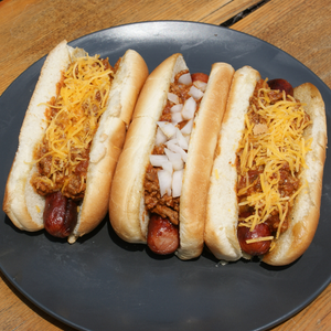 plate of three chili cheese hot dogs