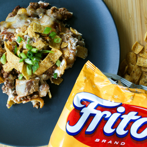 frito pie on a plate with bag of fritos