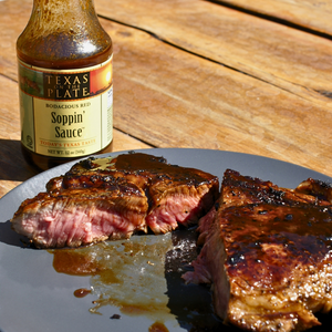 a plate with cooked steak and soppin' sauce