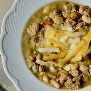  a bowl of white bean turkey chili with cheese